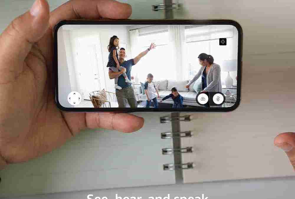A person is taking a picture of a group of people in a room.