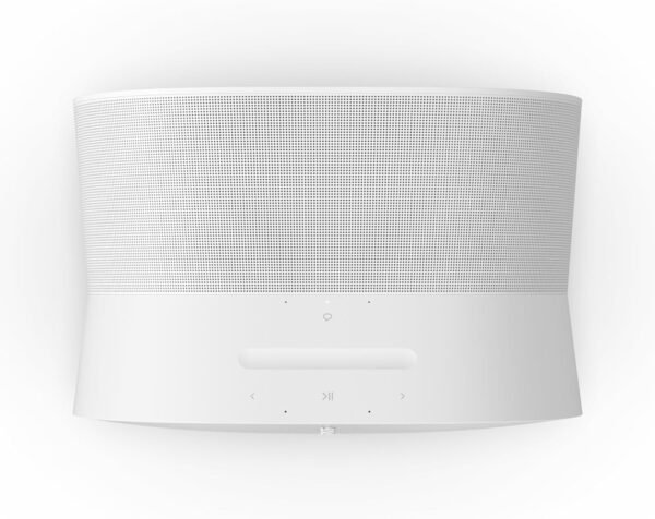 White smart speaker with a minimalist design featuring a curved front grille, integrated buttons for volume, play/pause, and other controls on the flat surface below the grille.